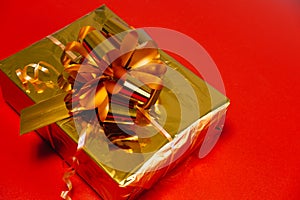 Gift close-up on a red background. Purchase online. Concept for Christmas, New Year 2022, Black Friday.