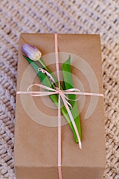 A gift, in a craft package with a purple tulip