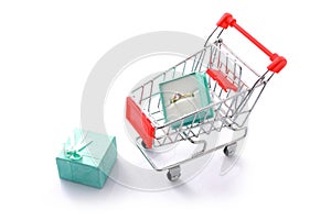 Gift diamond ring in shopping cart isolated