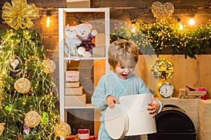 Gift emotions. Christmas child opening a present. Happy kid having fun with gift.