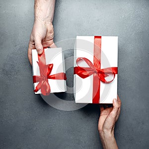 Gift exchange concept. Man changes gifts with a woman, top view. Birthday, Valentines Day, Anniversary, Holiday Concept