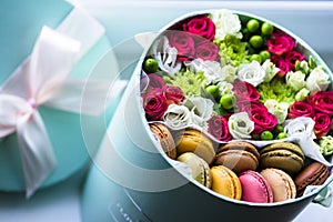 Gift flower box with fresh flowers and macarons.