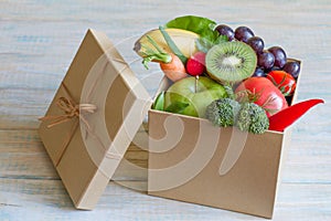 Gift of fresh fruits and vegetables on wooden board healthy diet lifestyle concept