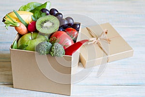 Gift of fresh fruits and vegetables on wooden board healthy diet lifestyle concept
