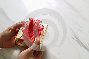 gift giving,man hand holding a gift box in a gesture of giving o