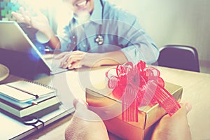 Gift Giving.Patient hand or Team giving a gift to a surprised Me