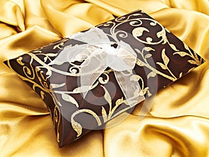 Gift at golden fabric