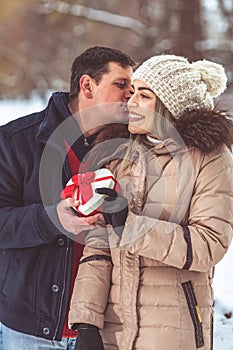 Gift hearts - Man gives a box with a gift to his girlfriend for valentines