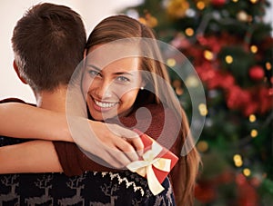 Gift, hug and couple with portrait, Christmas and festive season with marriage and holiday. Love, embrace and man with