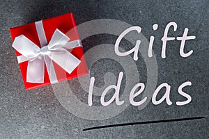 Gift ideas. Thinking about new year, Christmas and valentine day gifts and online shopping. Red box present with bow