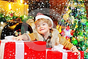 Gift kid emotions. New year Christmas concept. Happy kid having fun with big gift box. Kid having fun near Christmas