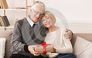 Gift With Love. Senior Man Giving Present To Wife