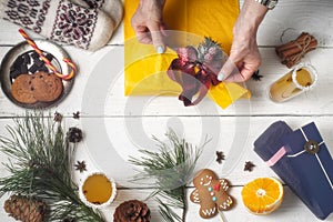 Gift packaging still life on the white wooden background top view