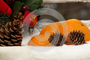 Gift, pinecones and tangerines on the christmas composition in