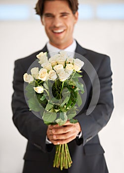 Gift, portrait and happy man with flowers for love, giving or valentines day celebration on wall background. Face, roses