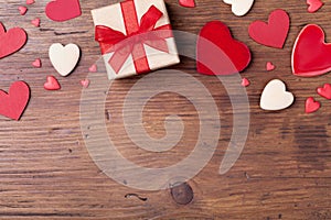 Gift or present box and mixed hearts for Valentines day background. Top view. Copy space for greeting text.