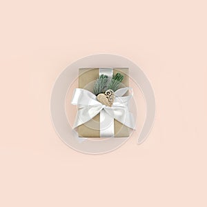 Gift or present box on pink background. Minimalist Christmas composition in trendy pastel color.