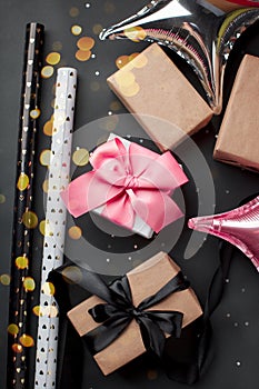 Gift present boxes wrapped with luxury pink blak bow on dark background. Vertical with copy space, seasonal sale, winter holiday,