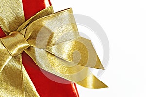 Gift red box with gold ribbon and bow isolated