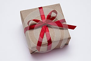Gift with red ribbon on white background