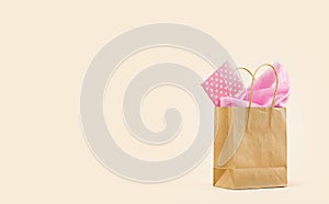 Gift or Sale concept. Shopping paper bag, with pink tissue