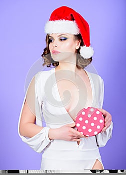 Gift from santa. Girl hold box opening christmas gift. Girl celebrate christmas. Girl wear santa claus hat. She has