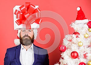 Gift service. Head downtrodden with thoughts what to gift. Man bearded formal suit carry gift box on head. Christmas