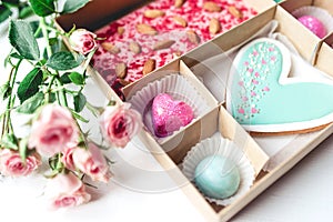Gift set with hand made sweets in a box on a white table.