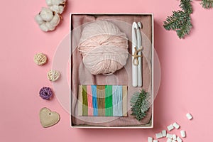 Gift set for lovers of needlework and knitting and embroidery. Soft yarn, crochet hooks and floss threads.