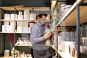 gift shop worker and gift wrapping tidy up the shelves in the store, Inventory concept