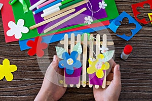 A gift of summer flowers on wooden sticks a fence on a wooden table. Handmade.