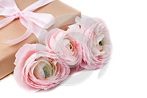 Gift tied with ribbon and pink flowers