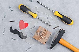 Gift and tools set on a gray background.