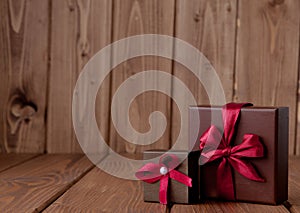 Gift on wooden table. Photo in old color image style