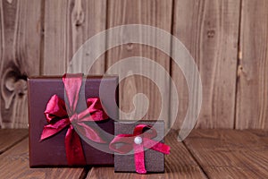 Gift on wooden table. Photo in old color image style