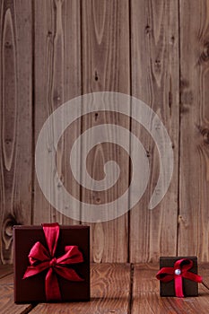 Gift on wooden table. Photo in old color image style