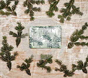 A gift wrapped in festive Christmas paper on a wooden background