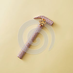 Gift wrapped hammer in yellow polka dot paper