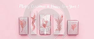 Gift wrapping banner. Pink nordic christmas gifts isolated on pastel pink background.