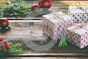 Gift wrapping. Christmas composition with present box, packing paper, festive decoration and fir tree branch. Preparation for holi