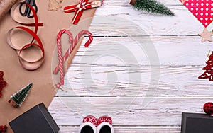 Gift wrapping. Packaging christmas present box in paper. Top view of white table, copy space