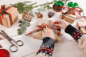 Gift wrapping. Packaging modern christmas present in boxes