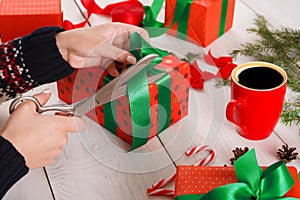 Gift wrapping. Packaging modern christmas present in boxes