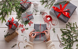 Gift wrapping. Packaging modern christmas present in boxes