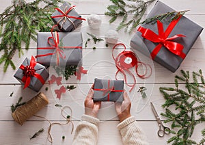 Gift wrapping. Packaging modern christmas present in boxes