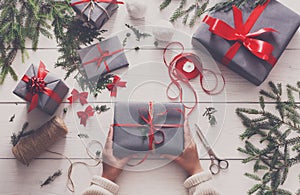 Gift wrapping. Packaging modern christmas present in boxes