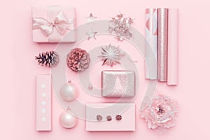 Gift wrapping. Pink nordic christmas gifts isolated on pastel pink background. Wrapped xmas boxes.