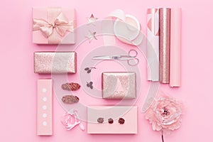 Gift wrapping. Pink nordic christmas gifts isolated on pastel pink background. Wrapped xmas boxes layout.