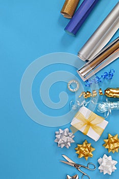 Gift wrapping utensils on cyan background