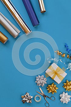 Gift wrapping utensils on cyan background